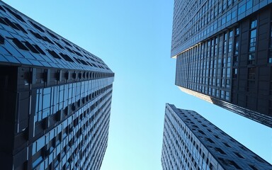 Looking Up modern high-rise office buildings with blue sky in the background. High quality