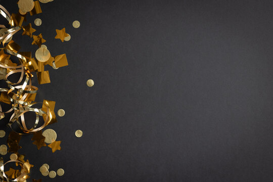 Border of gold streamers and stars on a black background