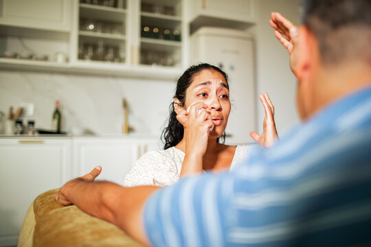 Adult couple arguing in home kitchen, upset and tearful - Powered by Adobe