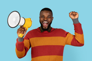 Portrait Of Joyful Black Man With Megaphone In Hands Making Announcement, Happy Excited African...
