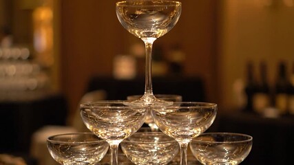 A close-up showcases a champagne glass tower with stems, perfect for a celebration or event - Powered by Adobe