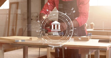 Crafting African-American carpenter in red shirt shaping wood plank at shop, with bank icon overlay