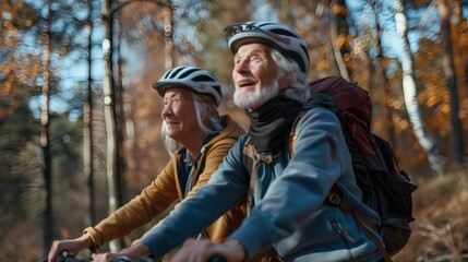 Happy senior couple enjoys a bike ride in autumn forest