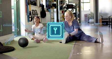 Reaching child, therapist in navy scrubs guiding on turf at clinic, medicine ball AR key icon