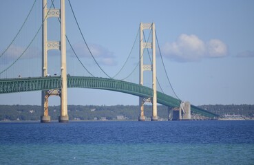 Mighty Mackinac Bridge connecting the Upper and Lower Michigan peninsulas .
