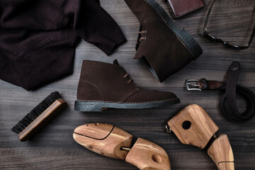 Chukka Boots and Accessories on Wooden Table