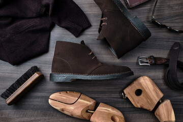 Chukka Boots and Accessories on Wooden Table