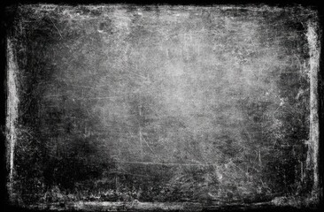 Fototapeta premium Old weathered blackboard with scratched and worn edges in classroom