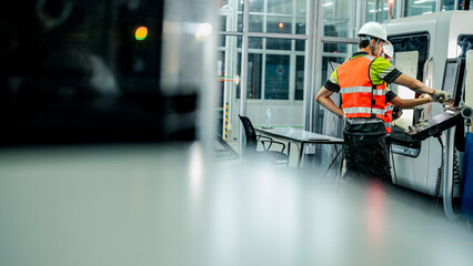 Three engineers program an industrial robot or 5-axis CNC machine using an AI interface. The team manufactures advanced microchips or high-tech components in a smart factory.