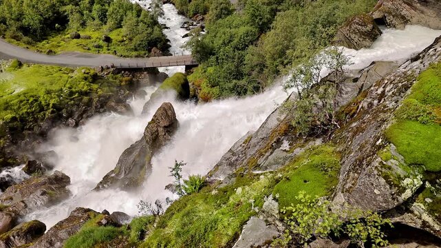 Bridge over the Kleivafossen waterfall on the way to Brikdalsbreen Glacier in Norway.