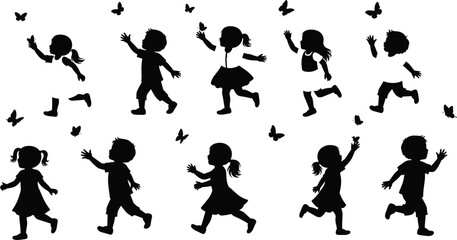 Obraz premium Silhouettes of Children Running and Playing with Butterflies Outdoors