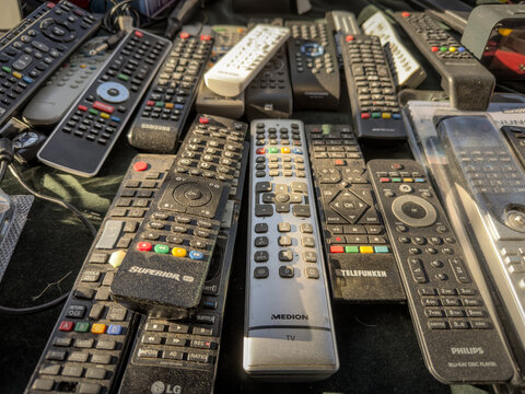 SABAC, SERBIA - SEPTEMBER 20, 2025: used TV remote controls laid out for sale at a flea market in Sabac. Mixed brands and models fill the table, on second hand consumer electronics, spare parts.