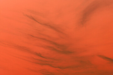 Illustration of orange silk background. Design and pattern for fabric, textile, paper, wallpaper. Dark orange sky illustration with black clouds.