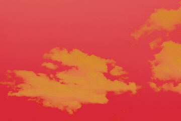 Red and yellow sky paint with clouds.  Abstract background in pink and orange. Gradient and red sky and yellow clouds. Pollution and environment.