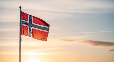 Norwegian flag waving proudly in the wind against a beautiful sunset sky. National symbol of Norway for patriotism and national pride.