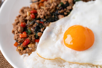 Thai food, Stir fried holy basil with minced pork with cooked rice and fried egg on top, Close up