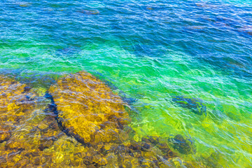 Rock rocks boulder boulders in turquoise green blue water Brazil.