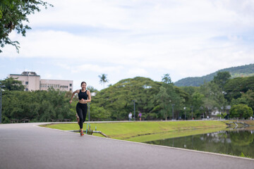 Fototapeta premium Woman running outdoors in park for fitness
