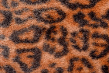 Dark leopard faux fur macro photo as a background.