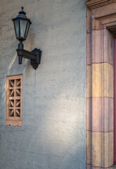 Islamic Style Mosque Wall with a Black Wrought Iron Lamp.