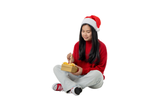 Girl in Santa hat opens gift box for winter, isolated, PNG