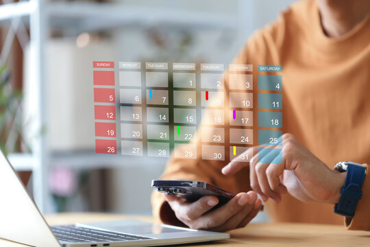 Businessman touching to smartphone with calendar and red circle mark for booking reminder appointment meeting and planing schedule concept.time management concept.