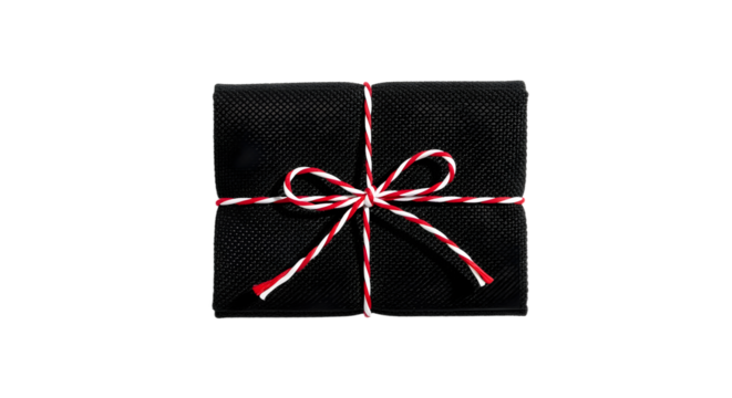 Gift - Black gift box wrapped with red and white striped ribbon, isolated on black background, perfect for holiday presents