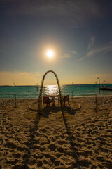 Tranquil closeup calm sea water waves with palm trees. Beautiful sunset. Tropical island beach landscape exotic shore coast. Summer vacation, holiday amazing nature, Maldives.