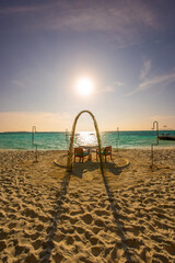 Tranquil closeup calm sea water waves with palm trees. Beautiful sunset. Tropical island beach landscape exotic shore coast. Summer vacation, holiday amazing nature, Maldives.