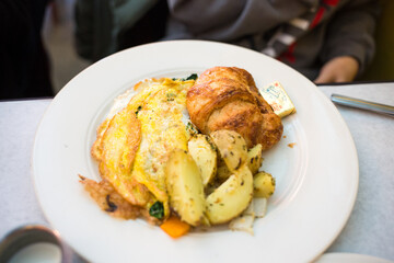 Breakfast Plate with Omelette, Croissant, and Roasted Potatoes