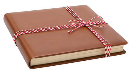 Gift - Brown leather bound book wrapped with red and white string bow on white background, ideal for gift or special occasion