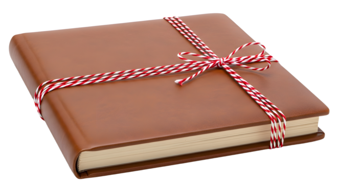Gift - Brown leather bound book wrapped with red and white string bow on white background, ideal for gift or special occasion