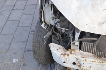 Fototapeta premium Damaged car tire and fender on city street