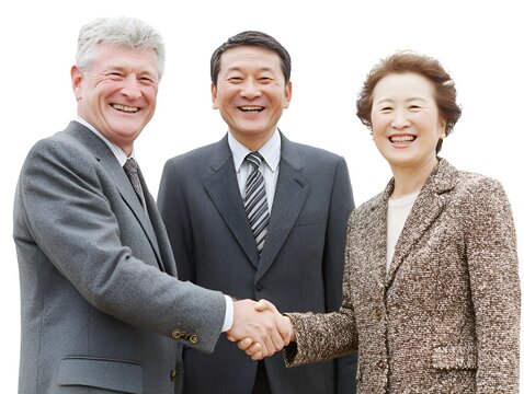 Diverse group of smiling businesspeople concludes a successful deal shaking hands in a positive environment.