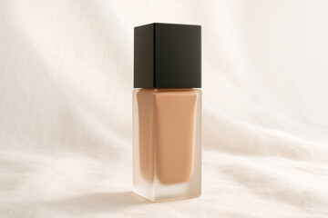 Glass Foundation Bottle Mockup with Black Cap on Fabric