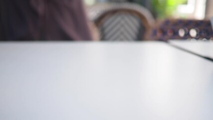 child hand reach for a Smartphone resting on a table  - Powered by Adobe