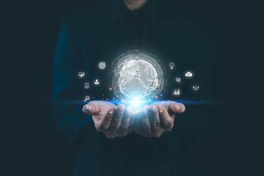 Businessman holding a glowing digital globe with futuristic technology icons, symbolizing innovation, data analytics, global connection, and business growth. Perfect for AI, fintech, and digital.