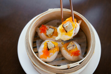 Chopsticks Holding Gourmet Dim Sum with Foie Gras and Roe