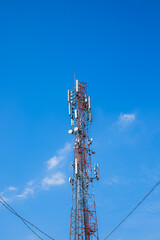 Telecommunication high tower with cellular network antennas on blue sky background. Satellite pole communication technology industry. 