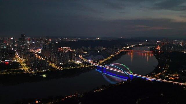 Drone Footage Gliding Over the Illuminated Nanning Bridge, Reflecting on Yong River