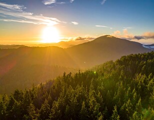 Aerial view captures a radiant sun setting over a mountain range with lush green forests, illuminating the sky with golden light