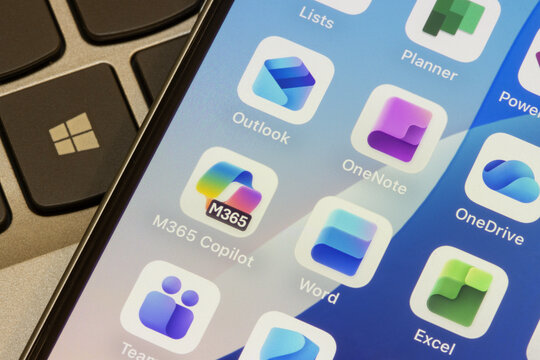 Portland, OR, USA - Nov 5, 2025: Microsoft 365 apps, including M365 Copilot, Word, Excel, Teams, Outlook, OneNote, OneDrive, and Planner, are seen on the screen of an iPhone.