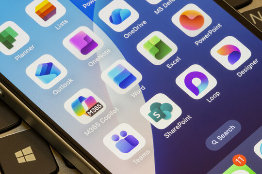 Portland, OR, USA - Nov 5, 2025: Microsoft 365 apps, including M365 Copilot, Word, Excel, PowerPoint, Outlook, OneNote, OneDrive, Planner, Teams, SharePoint, Loop, and Designer, are seen on an iPhone.