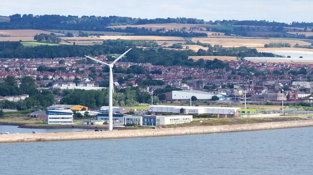 Wind Turbine Rotating on Dundee Coastal Industrial Landscape