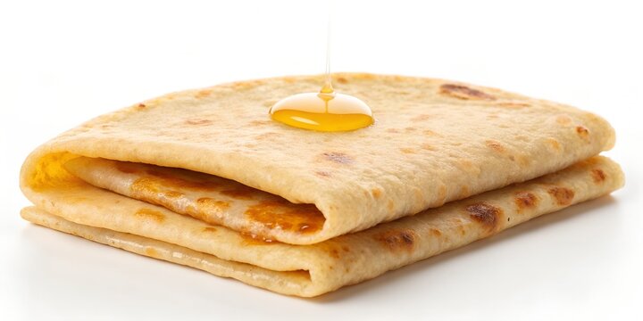 puran poli flatbread folded in half with golden ghee drop
