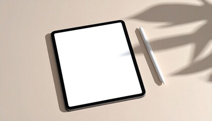 Tablet with stylus on beige background with leaf shadows.