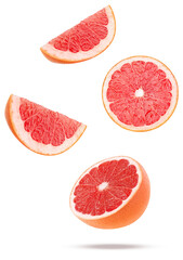 dynamic studio shot of fresh red grapefruit slices and halves floating or flying in motion against a transparent background, high speed photography.
