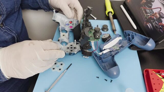 Technician repairing a broken video game controller