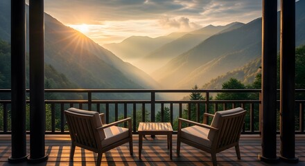 Serene mountain resort balcony with chairs and table overlooking misty valley at sunrise
