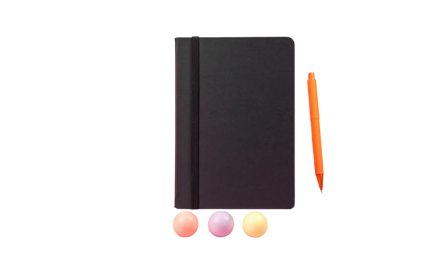 Black, closed notebook next to an orange pen and three gumballs, isolated on black - Powered by Adobe